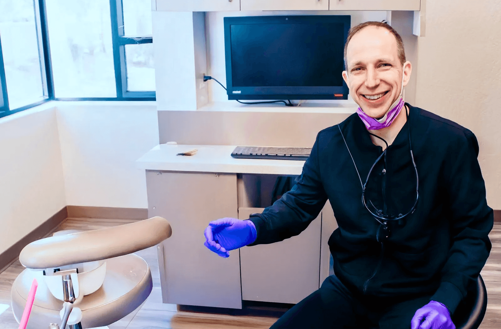 Doctor Gailey smiling while he welcomes a patient